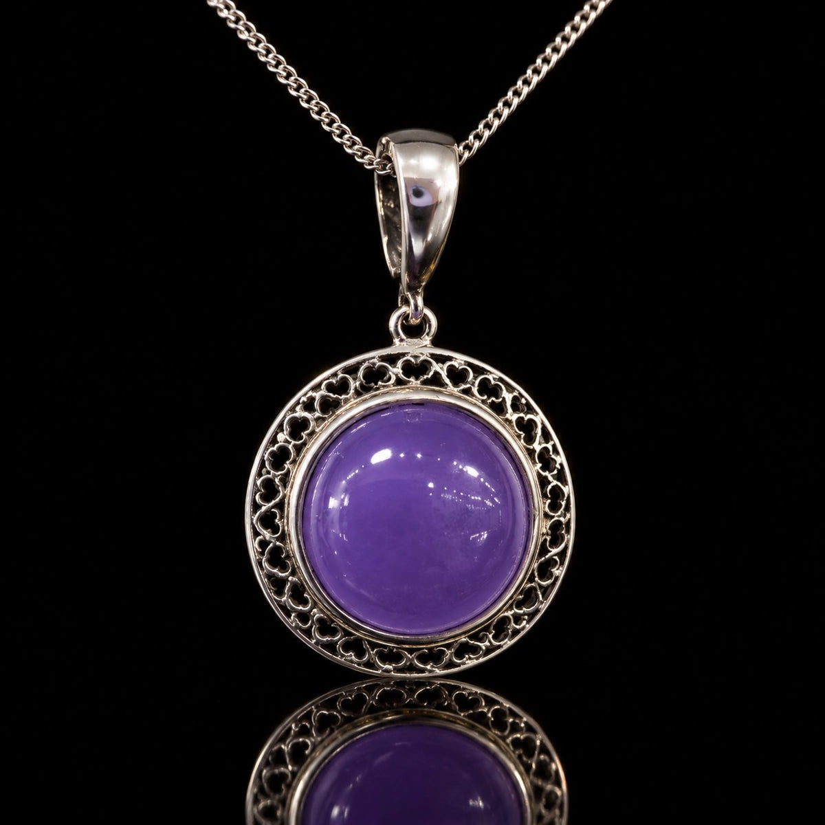 Vintage sterling silver filigree pendant with round purple cabochon, front view. Item 894178.