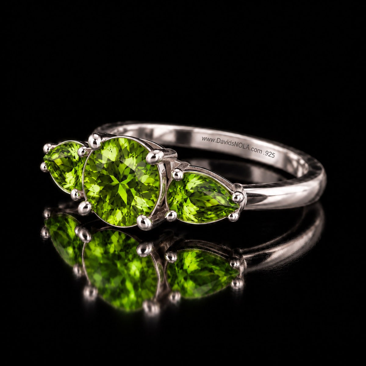 The same VooDooStone three-stone ring in peridot green, angled view. Item 894786.