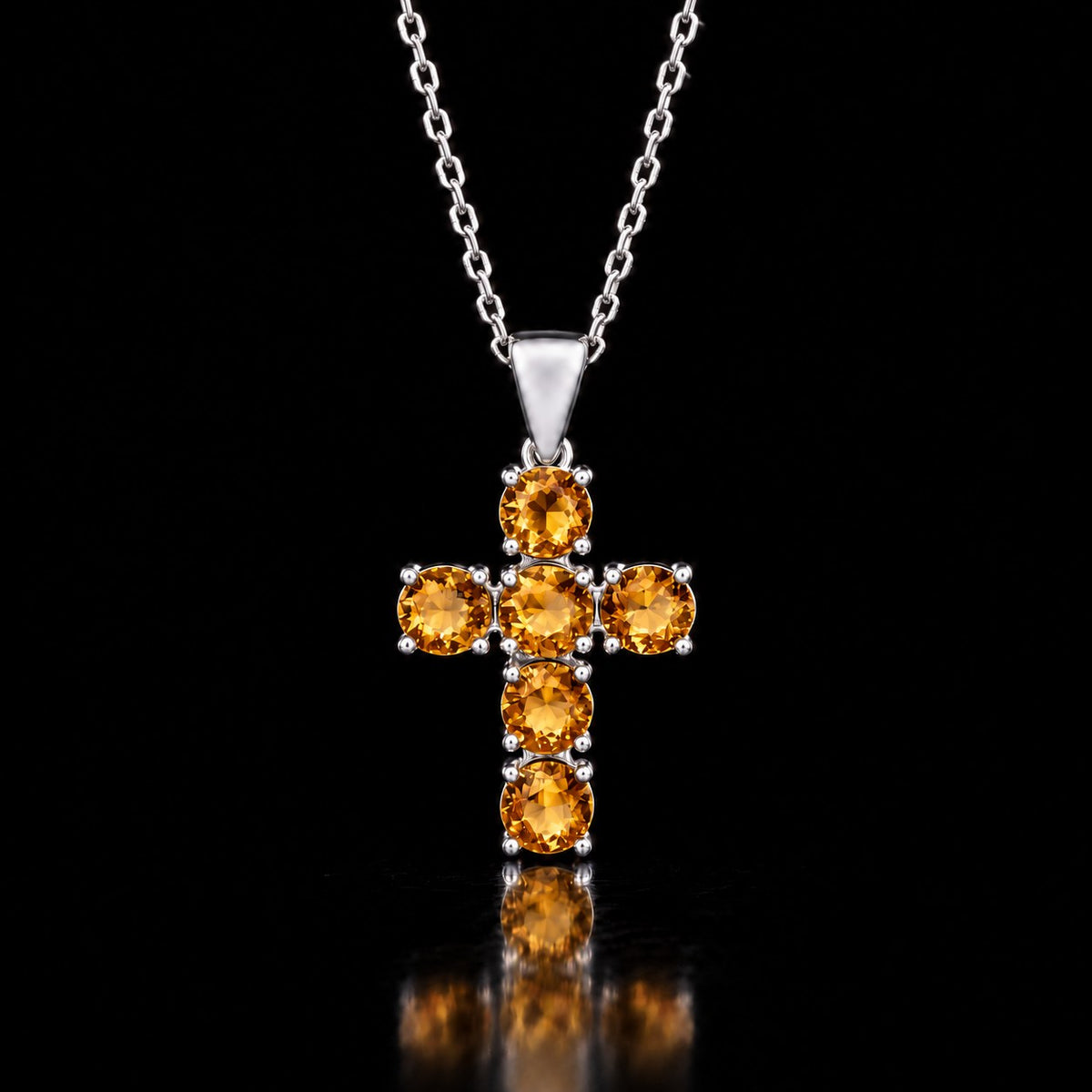 The same VooDooStone cross pendant turning golden amber under warm incandescent light. Chain shown for scale, not included. Item 894790.