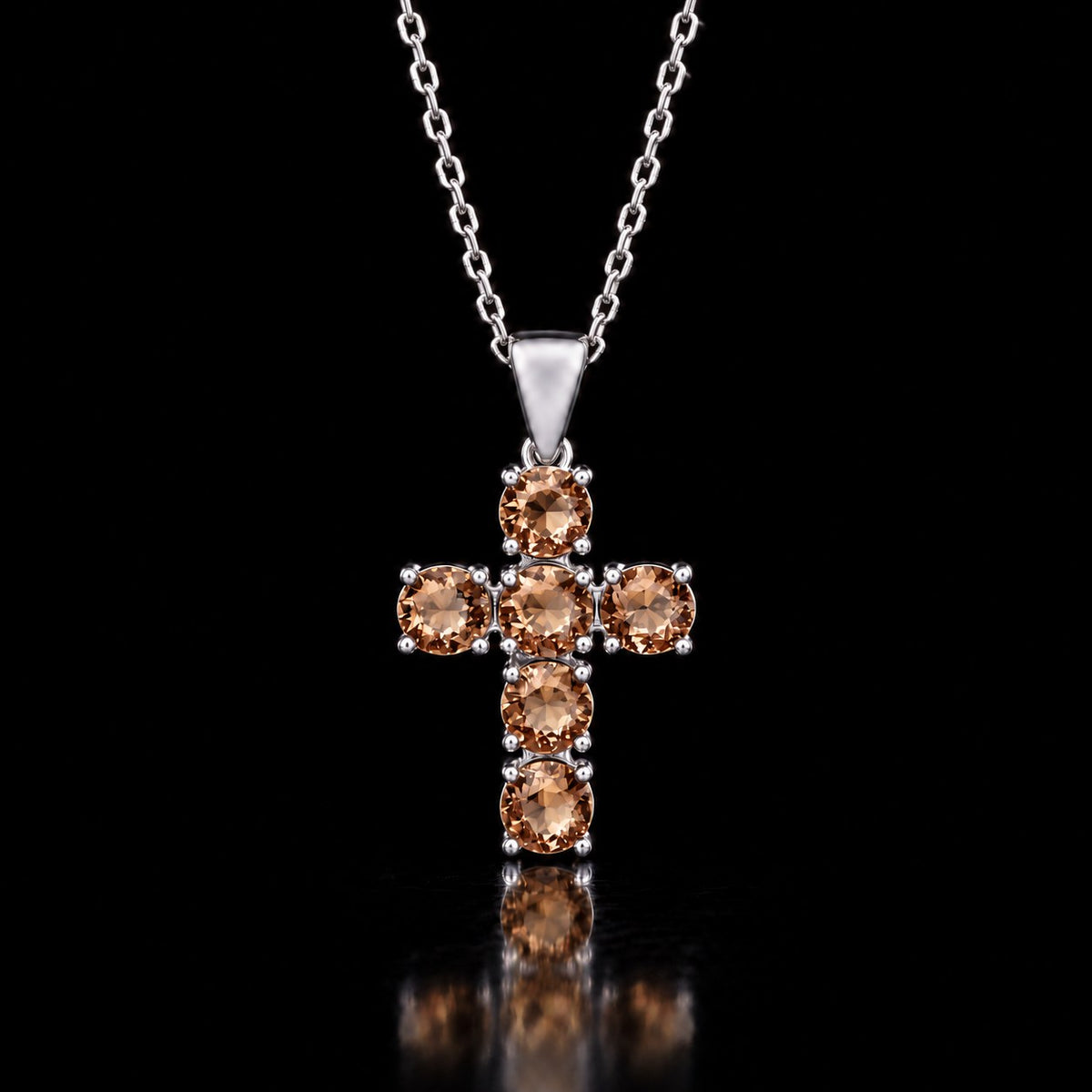 Sterling silver VooDooStone cross pendant with six round stones, purplish-pink in daylight, hanging from a chain shown for scale. Chain not included. Item 894790.