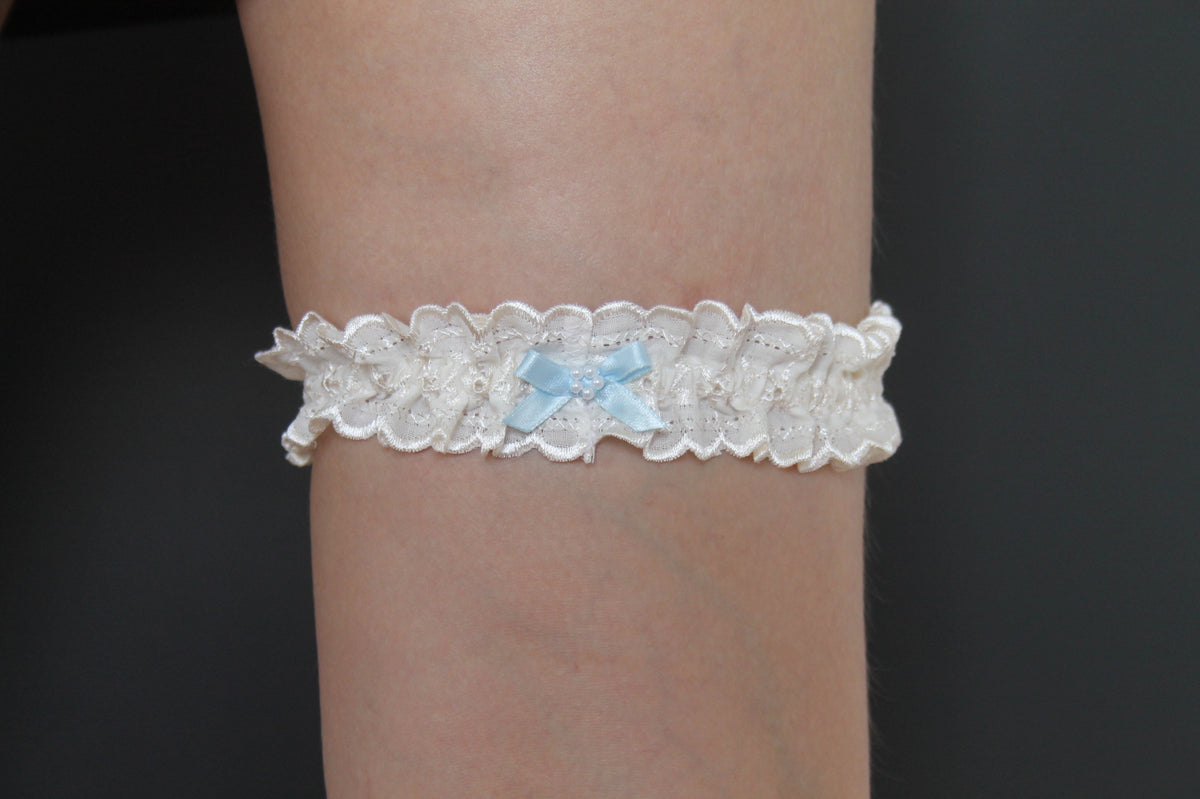Sophisticated Elegance: Delicate Ivory Wedding Garter with Blue Satin Bow