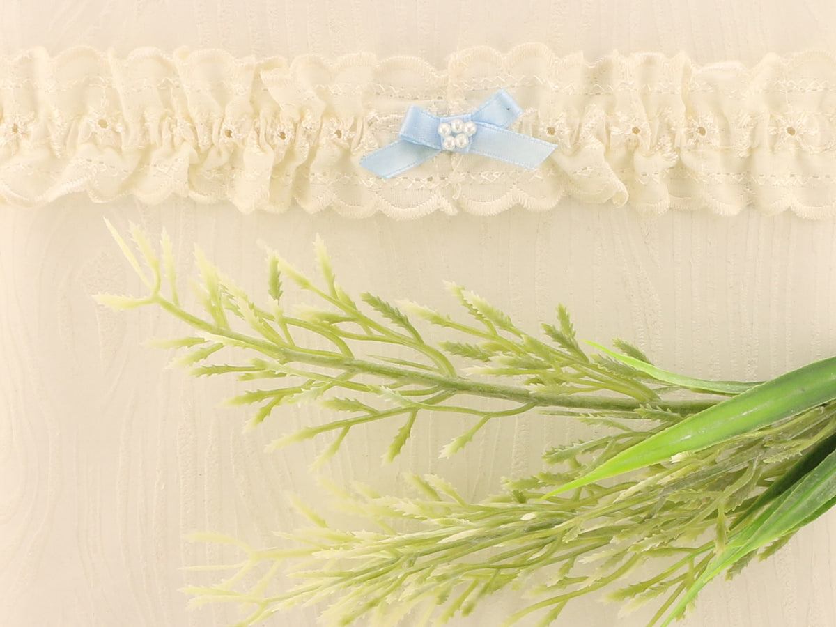 Sophisticated Elegance: Delicate Ivory Wedding Garter with Blue Satin Bow