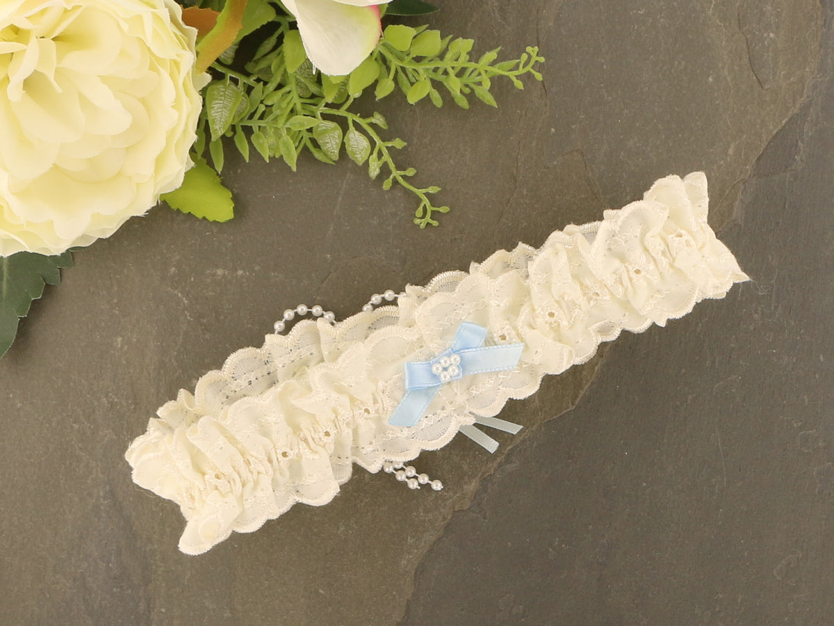 Sophisticated Elegance: Delicate Ivory Wedding Garter with Blue Satin Bow