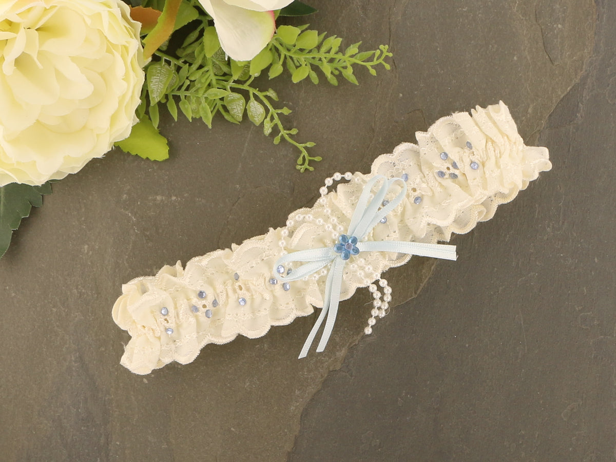 Sophisticated Elegance: Delicate Ivory Wedding Garter with Blue Satin Bow