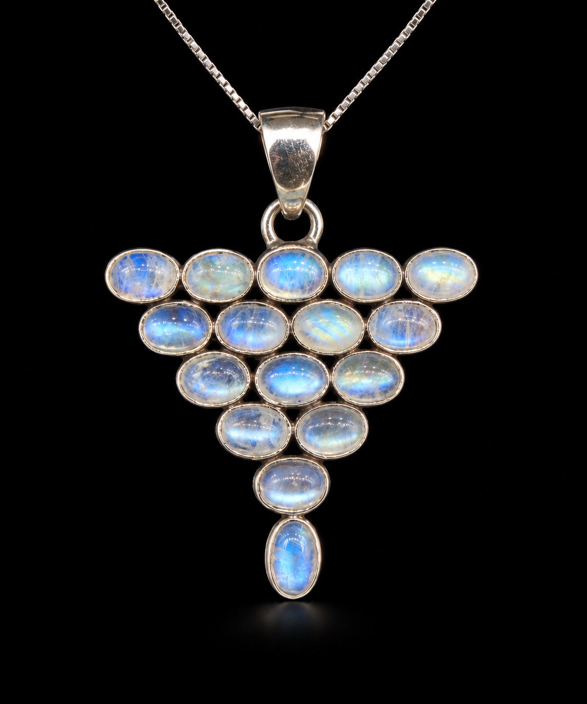 Sterling silver triangle pendant set with oval rainbow moonstones showing blue flash, front view. Item 892060.