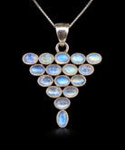 Sterling silver triangle pendant set with oval rainbow moonstones showing blue flash, front view. Item 892060.