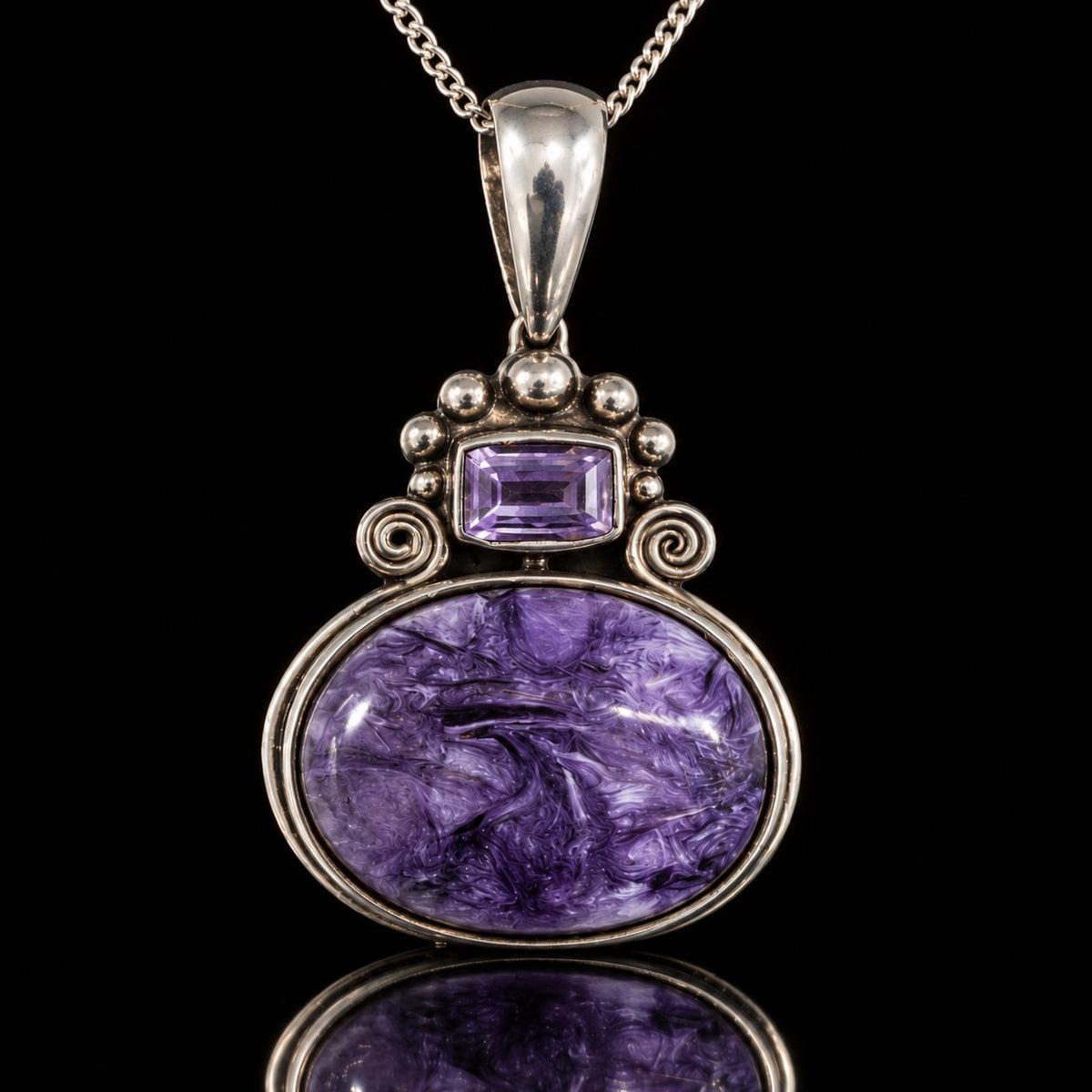 Vintage sterling silver pendant with purple charoite oval and amethyst accent, front view. Item 893725.