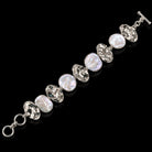 Sterling silver bracelet with oval blister pearls and ornate silver links, toggle clasp. Item 894012.