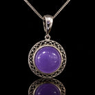 Vintage sterling silver filigree pendant with round purple cabochon, front view. Item 894178.