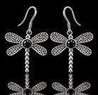 Sterling silver dragonfly earrings with textured wings and black onyx centers on French hooks. Item 894404.
