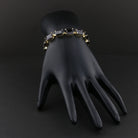 Garnet line bracelet on a black display hand. Item 894562.