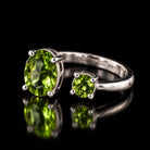 Sterling silver VooDooStone open gap ring, peridot green stones, angled view