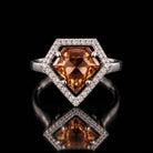 The same VooDooStone shield-cut halo ring in golden amber, angled view. Item 894784.