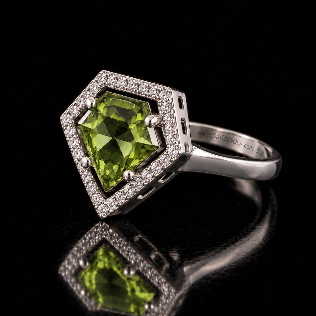 The same VooDooStone shield-cut halo ring in peridot green, angled view. Item 894784.
