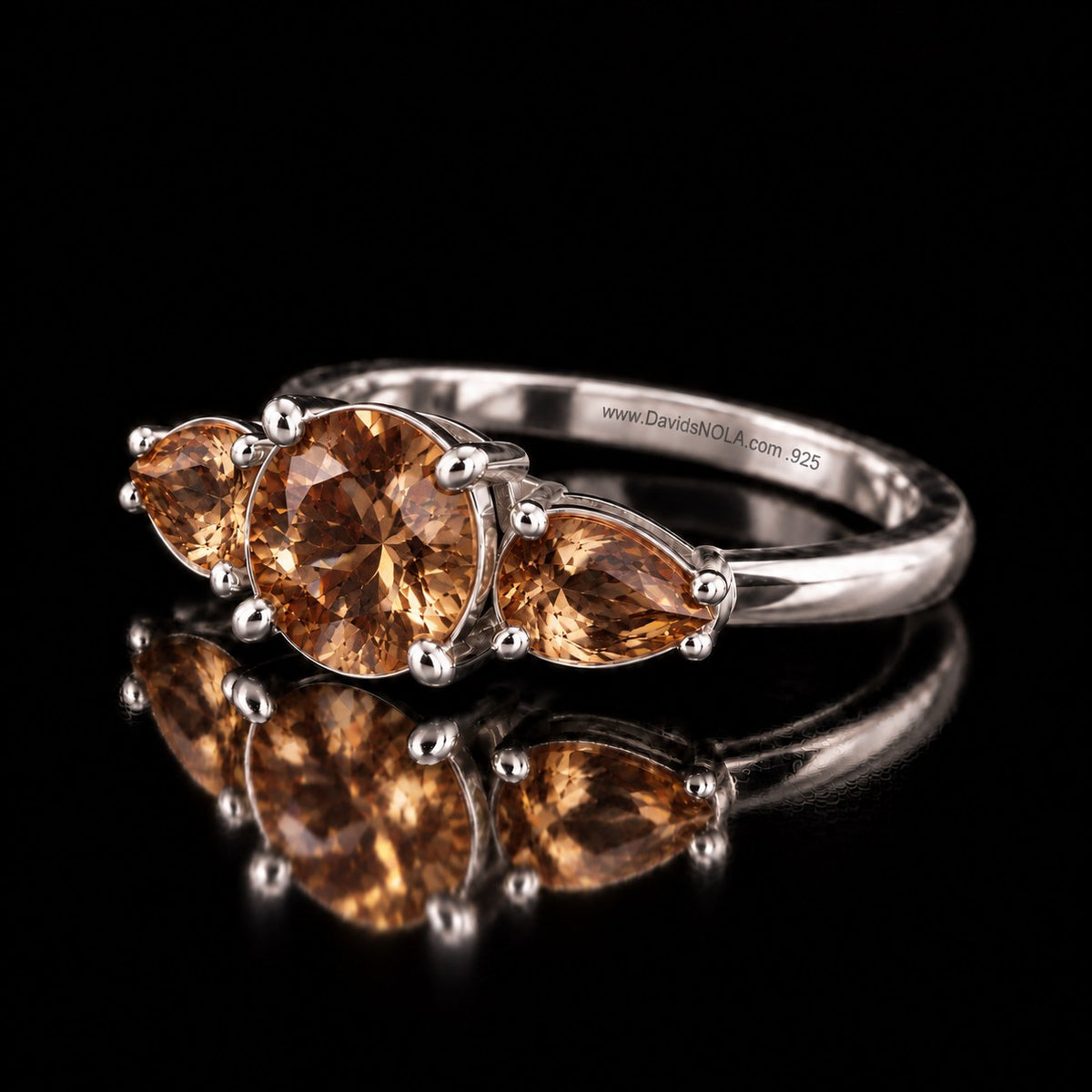 The same VooDooStone three-stone ring in golden amber, angled view. Item 894786.