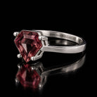 VooDooStone shield-cut ring in purplish-pink, angled side view. Item 894787.