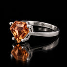 VooDooStone shield-cut ring in golden amber, angled side view. Item 894787.