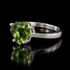 VooDooStone shield-cut ring in peridot green, angled side view. Item 894787.